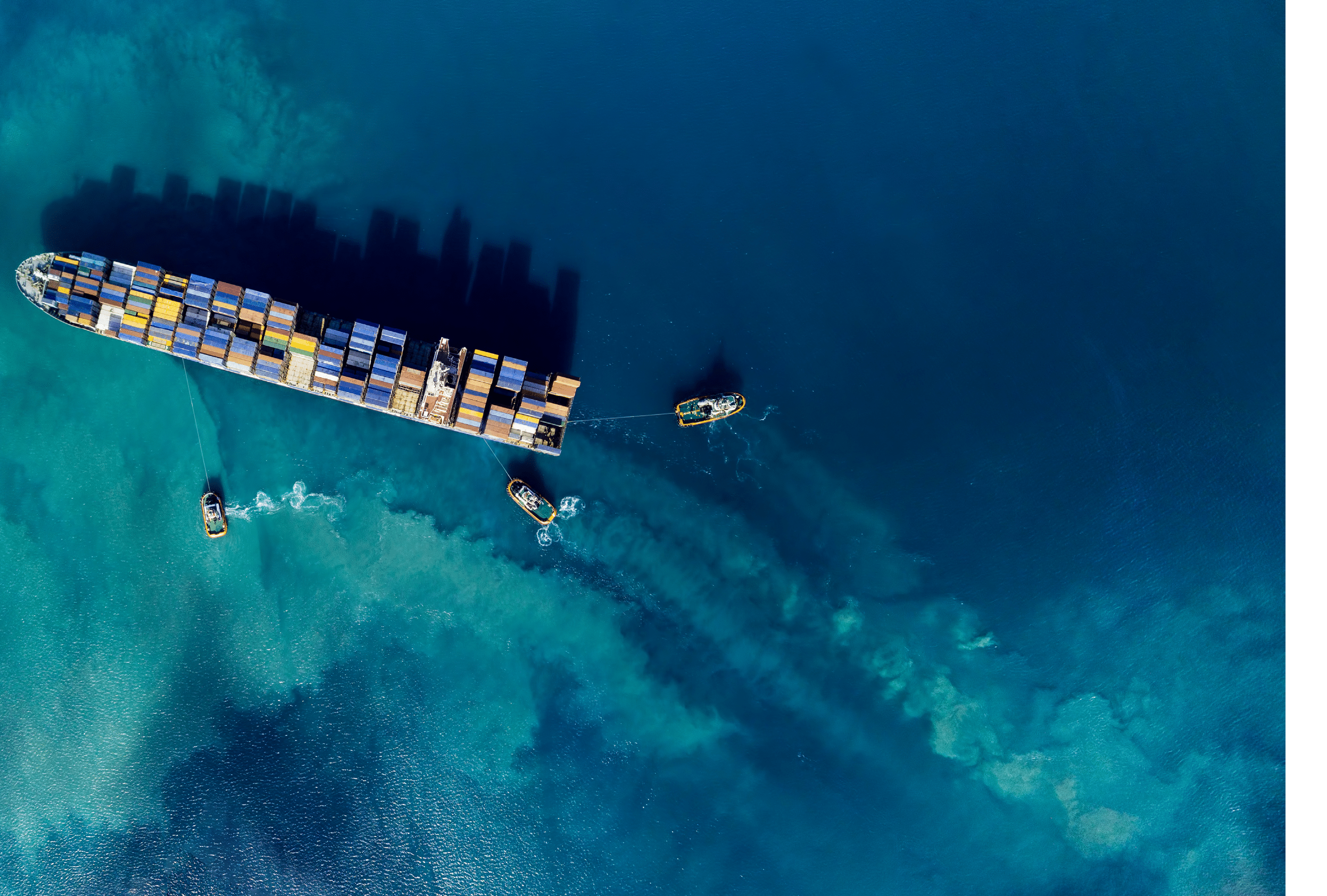 Aerial shoot of a cargo ship mooring in a harbour